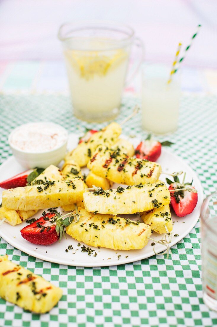 Grilled pineapple with strawberries and mint sugar