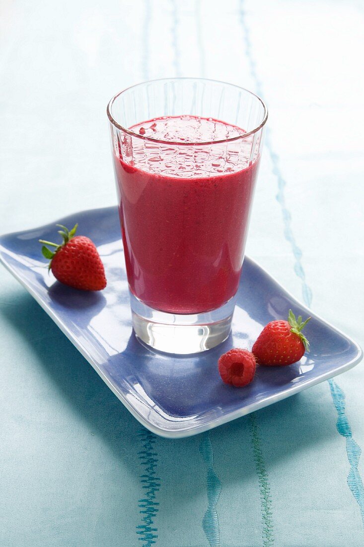 A berry smoothie with fresh strawberries and raspberries