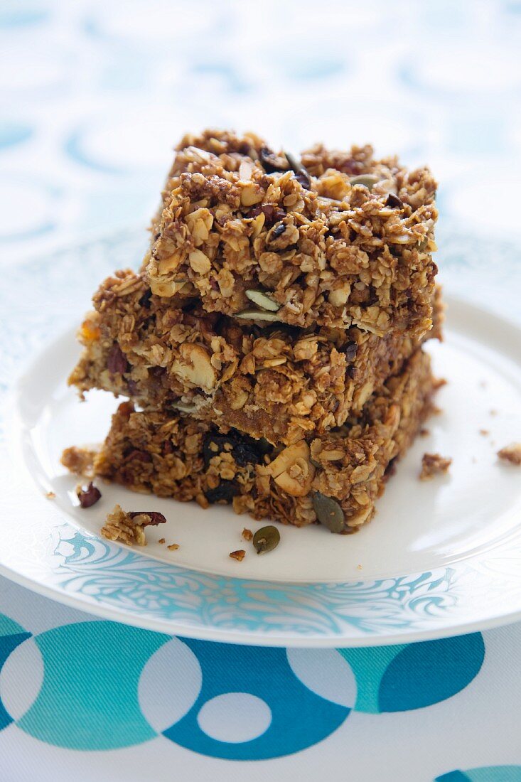 A stack of three muesli bars on a plate