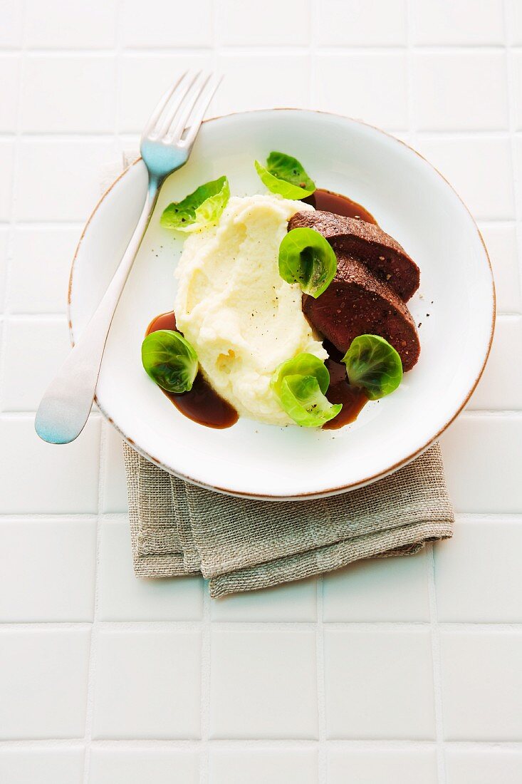 Mashed potatoes and celery with saddle of venison and Brussels sprouts