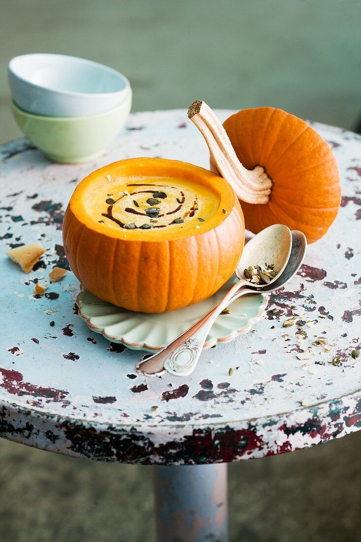 Pumpkin soup with pumpkin seeds served in a hollowed out pumpkin