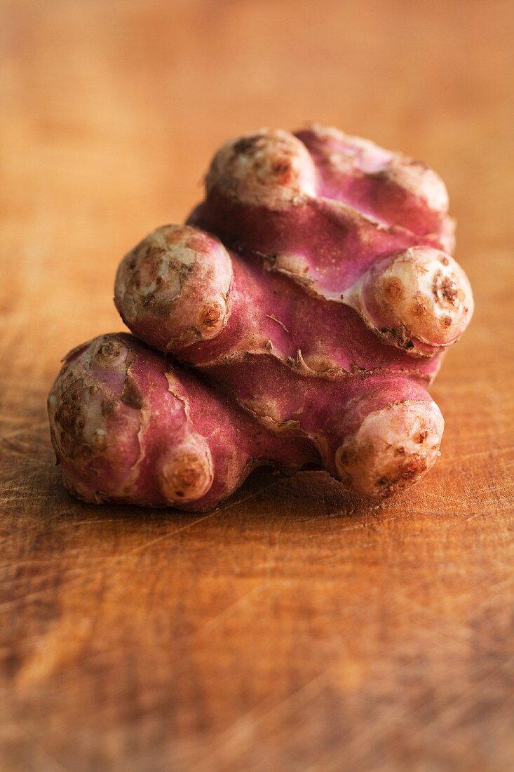 Jerusalem artichokes on wooden background