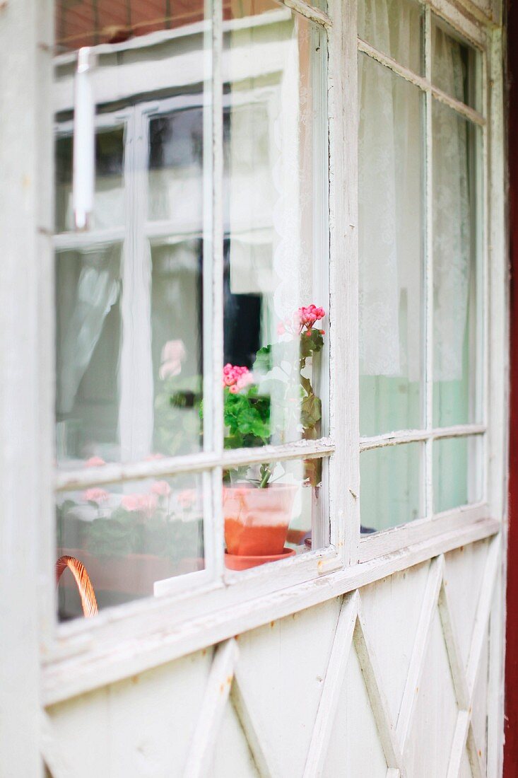 Porch with windows at entrance to old, Swedish wooden house