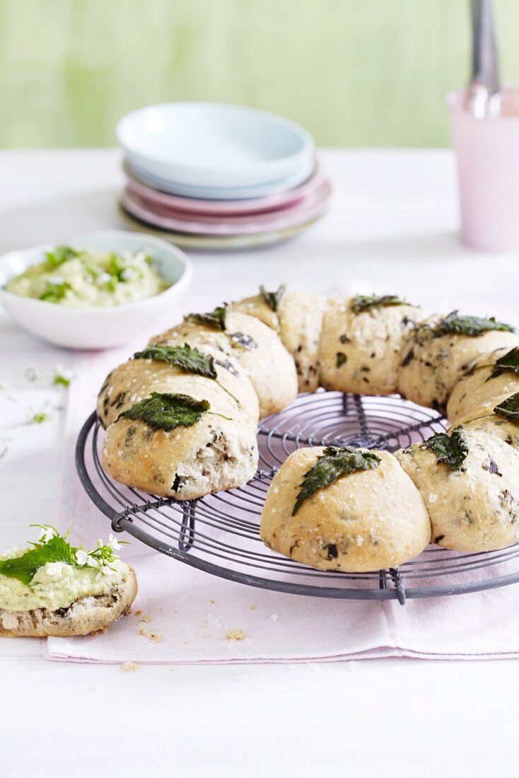 A stinging nettle bread wreath on a wire rack