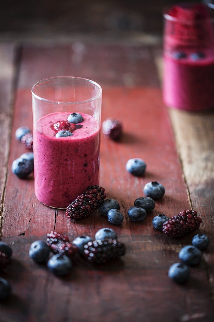 A blueberry and blackberry smoothie on a wooden table