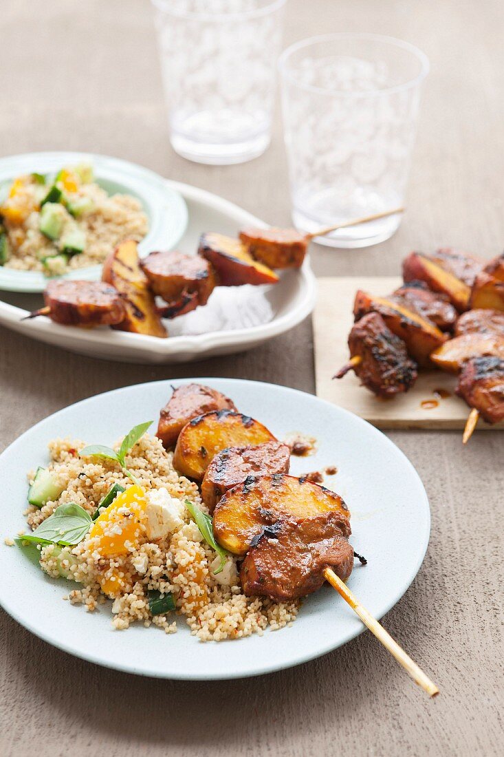 Peach and pork skewers with couscous salad