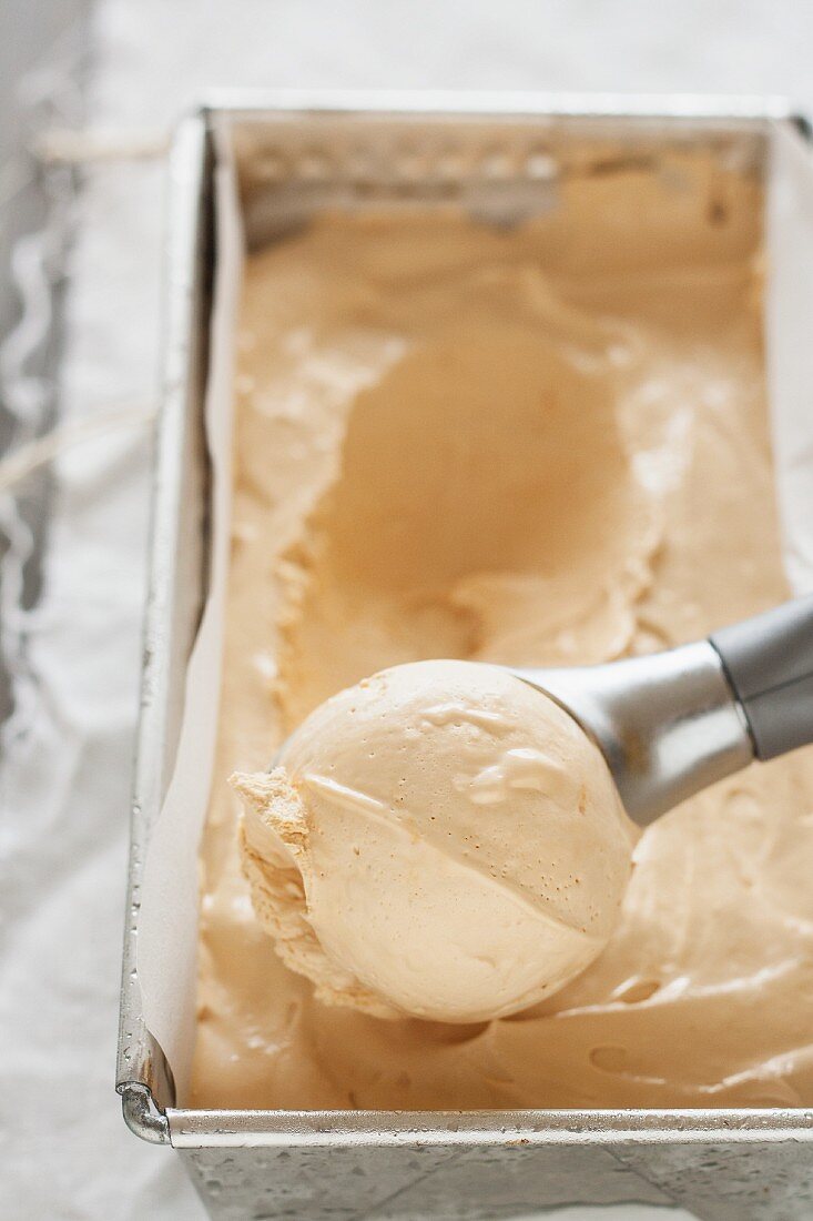 A scoop of ice cream in an ice cream scoop