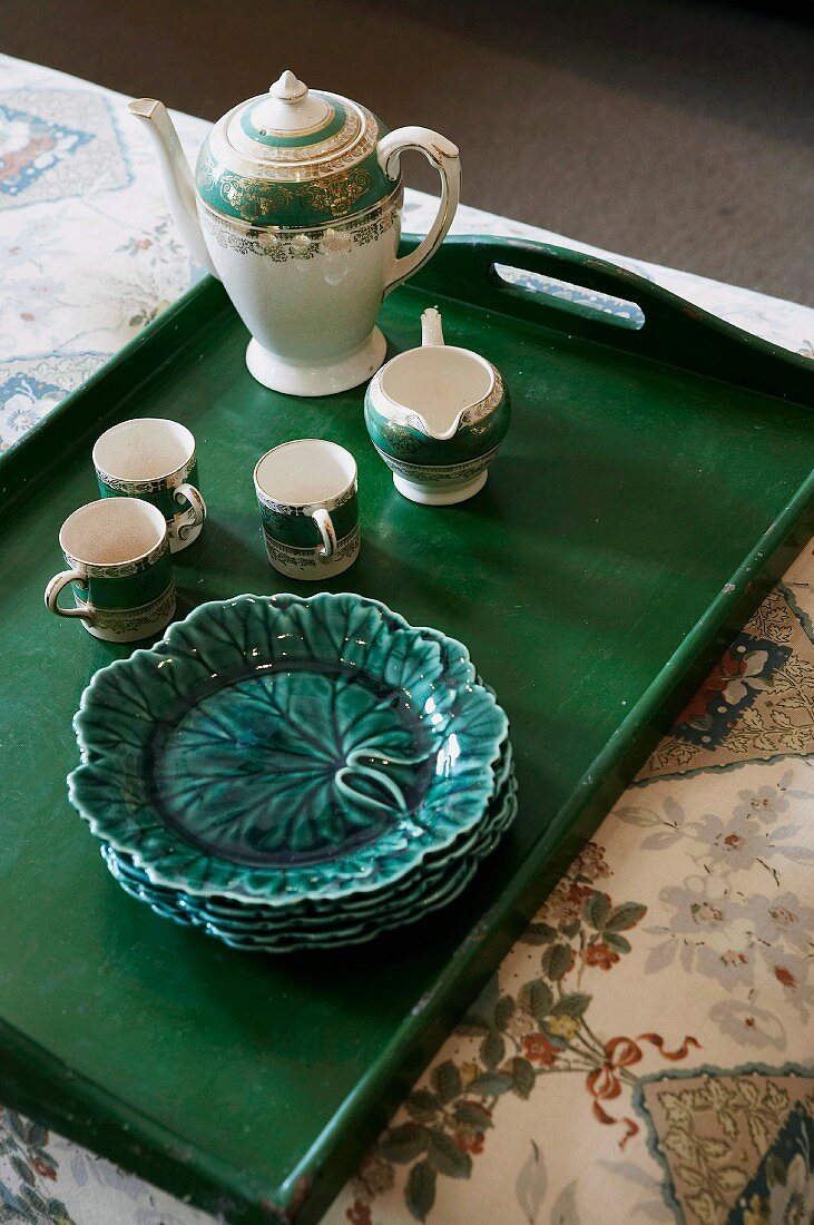 China tea set and cabbage-leaf plates on dark green wooden tray
