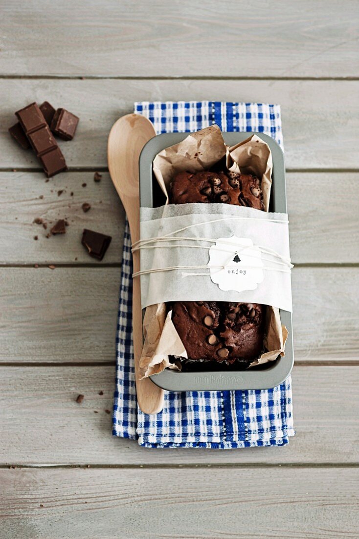 Chocolate cake and kitchen utensils wrapped as gift