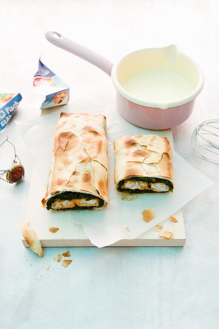 Fish finger and spinach strudel with champagne sabayon
