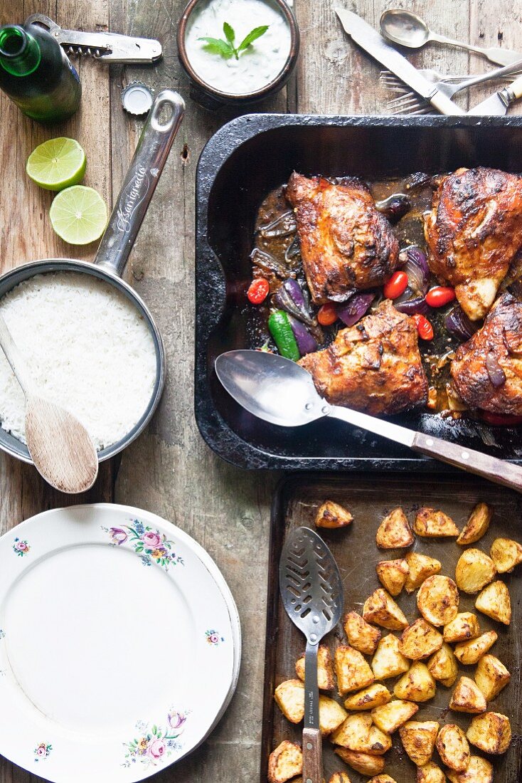 Tandoori chicken legs with basmati rice, potatoes and raita