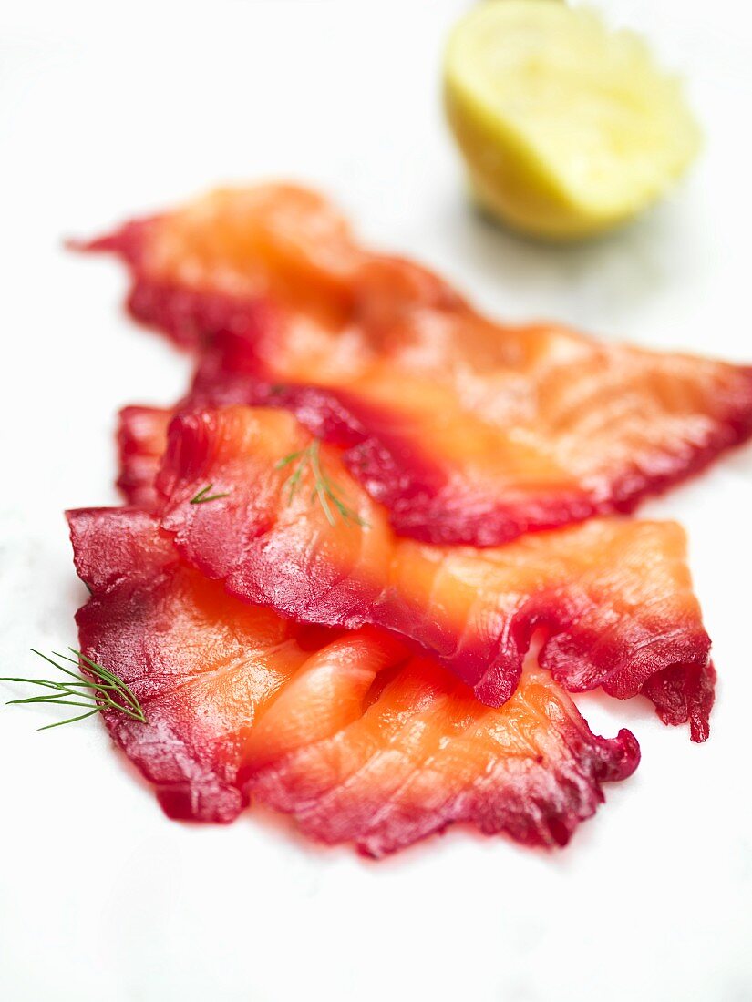 Slices of smoked salmon with dill and lemon