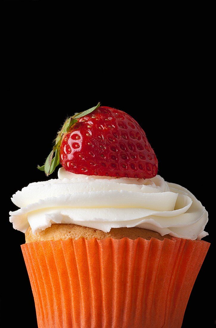 A strawberry cupcake topped with cream