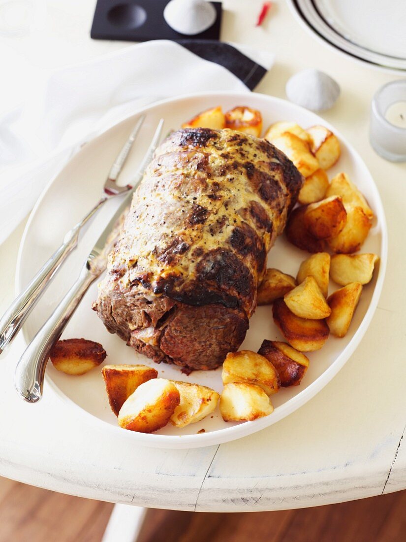 Roast beef with a mustard glaze and roast potatoes