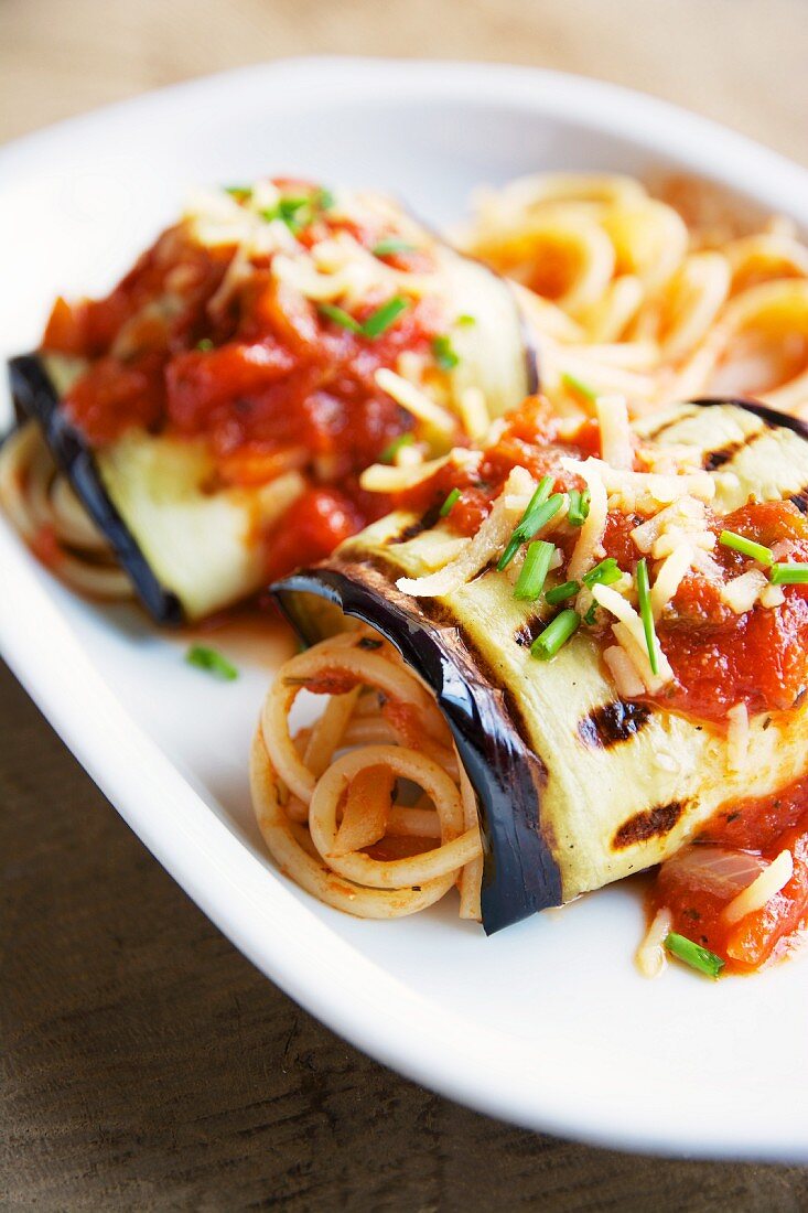 Grilled aubergine rolls with tomato sauce and spaghetti