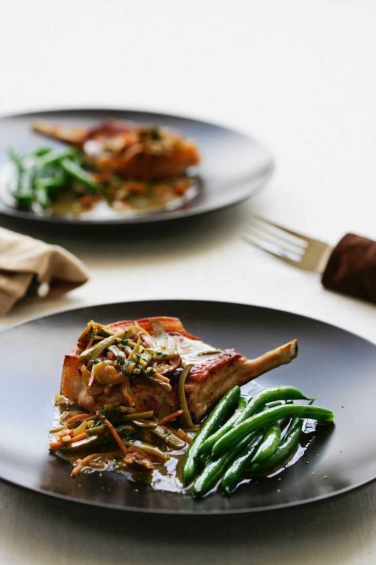 Pork chops with an olive sauce and green beans