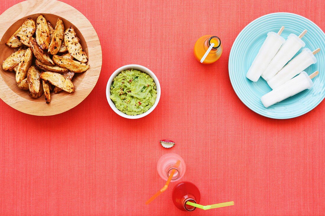 Potato wedges and guacamole with ice lollies