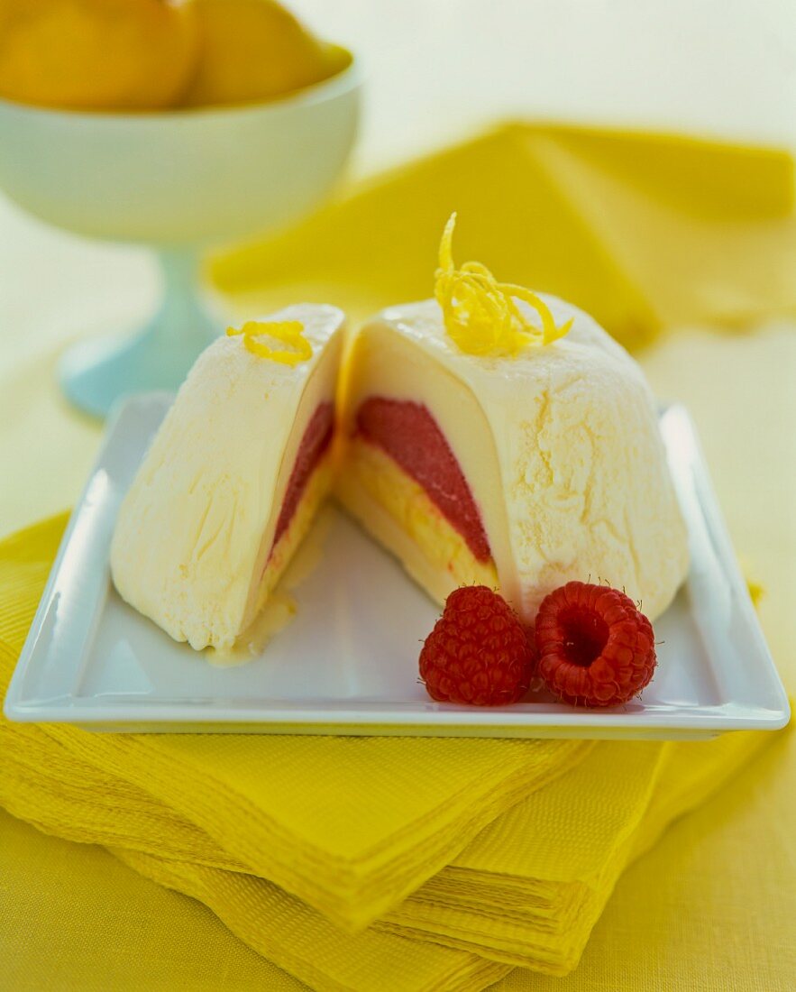 A lemon and raspberry ice cream bomb, sliced