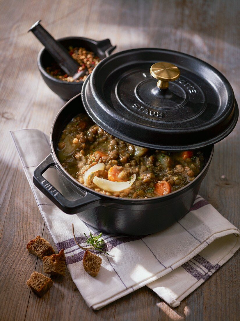 Lentil soup with croutons in a pot