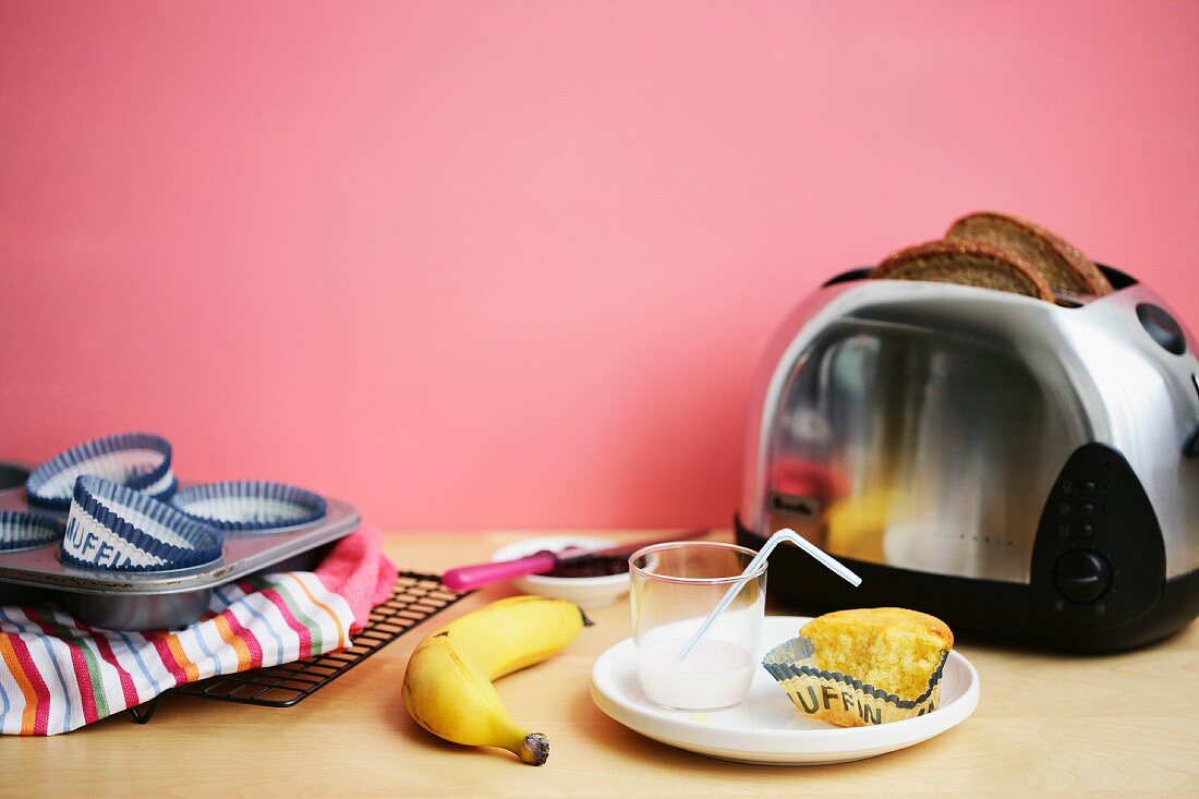 A muffin, milk, banana and toast for breakfast