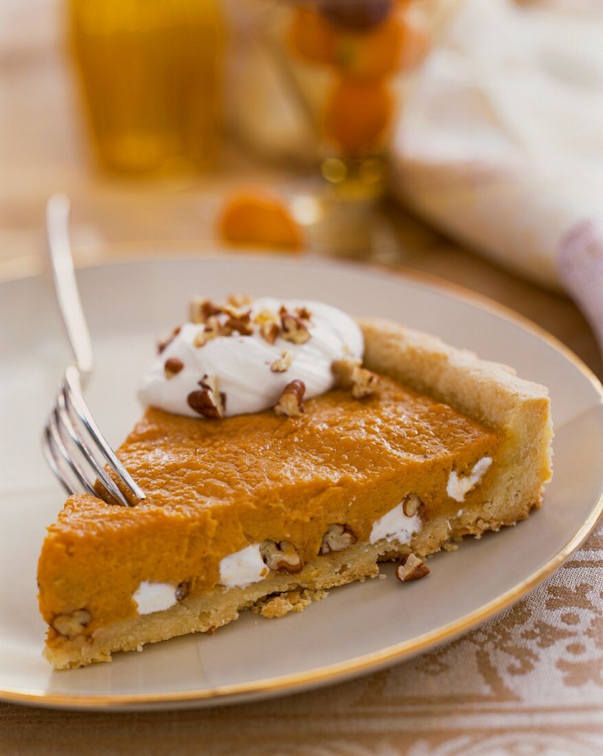 A slice of pumpkin pie with nuts