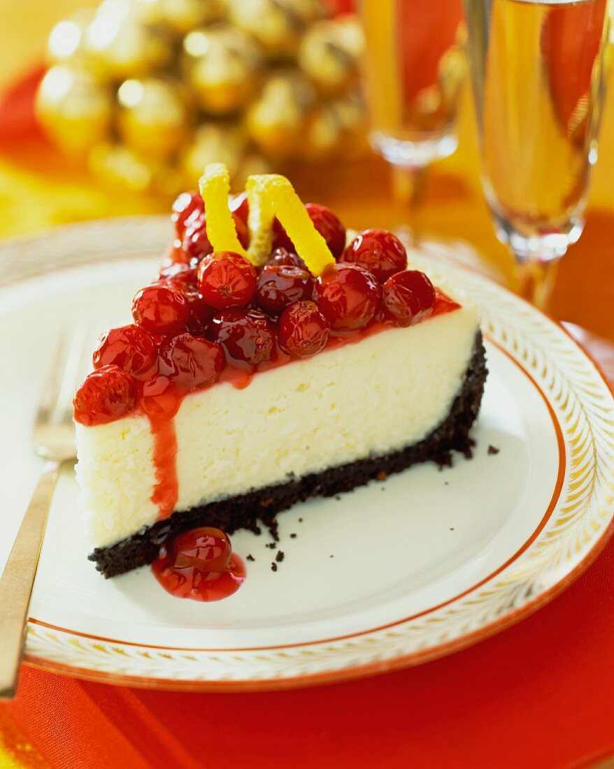 A slice of cheesecake with cranberry sauce