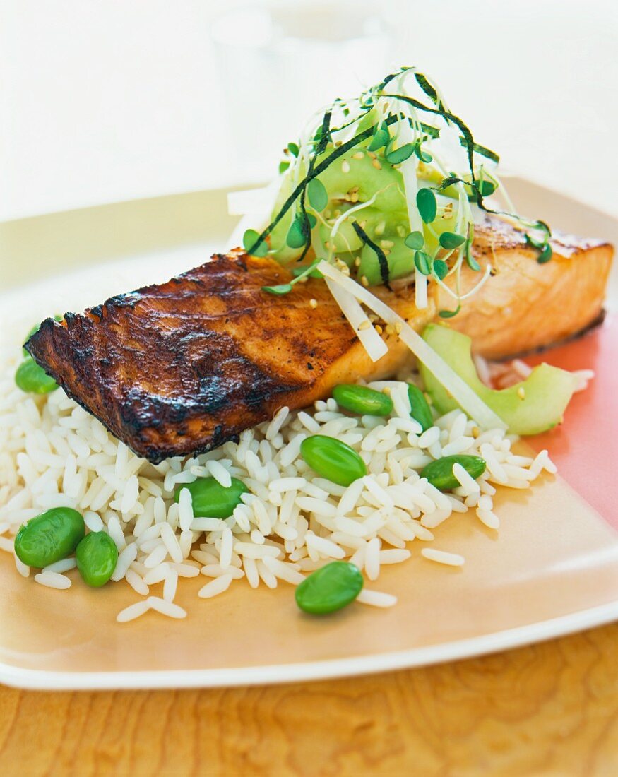 Salmon fillet on a bed of rice with broad beans