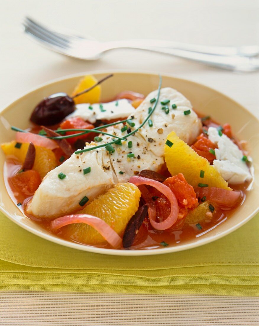 Fish fillet with oranges, tomatoes and olives