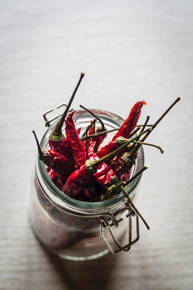 Dried red chilli peppers in a jar