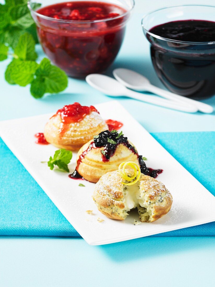 Three sponge cakes with a vanilla cream filling and fruit sauces