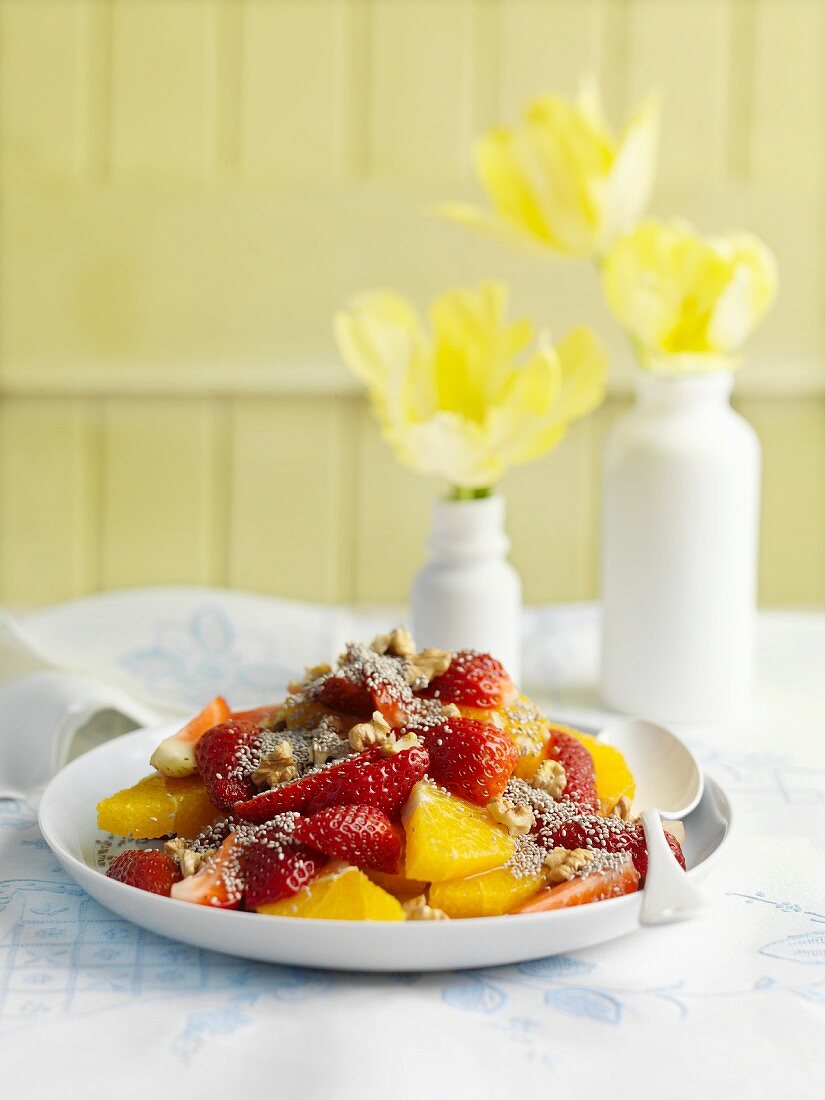 Fruit salad with strawberries, oranges, chia seeds and walnuts
