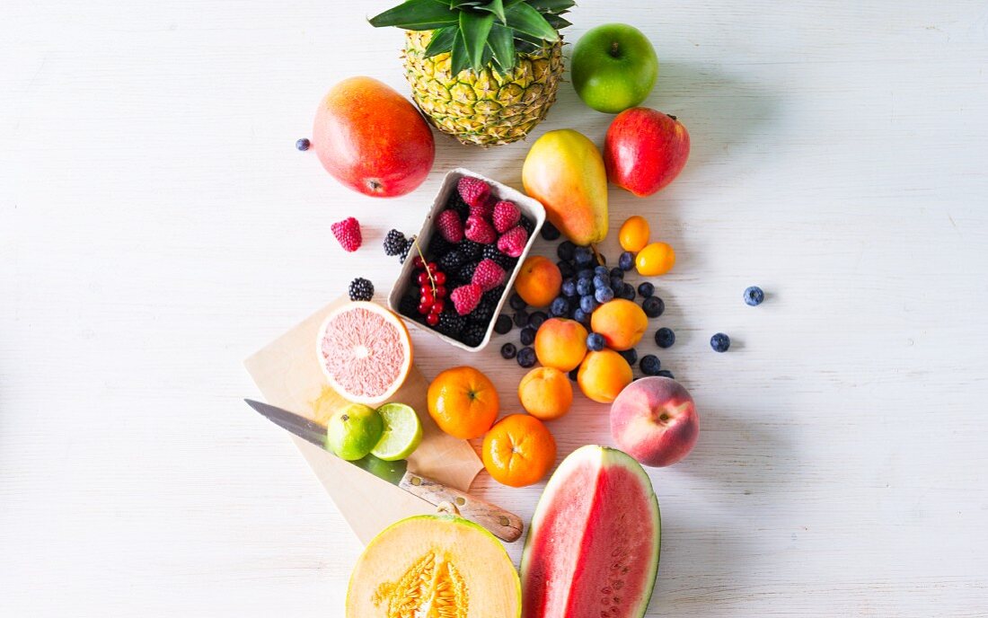 Various types of fruit against white background