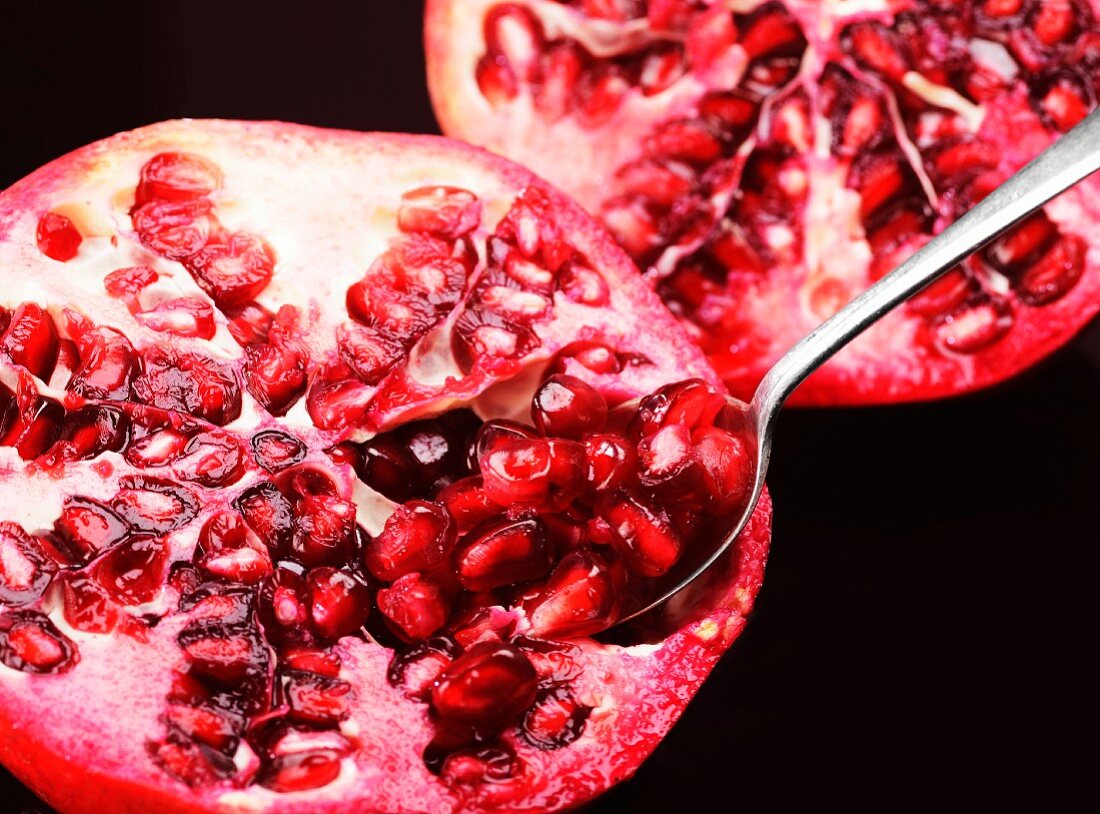 A pomegranate with a spoon