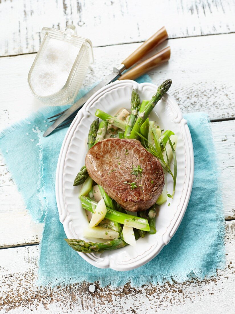 Beef steak fillet on a bed of spring vegetables