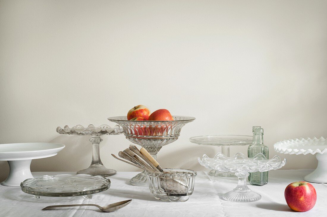Various cake plates and stands with apples