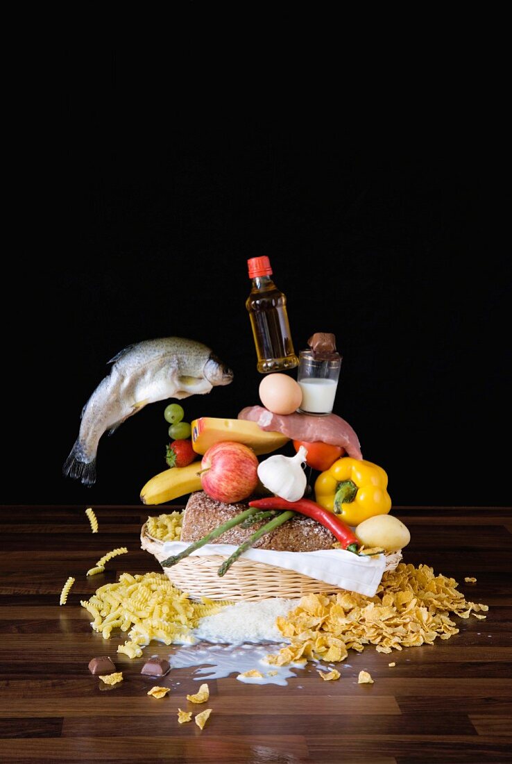 A stack of groceries in a breadbasket on a table