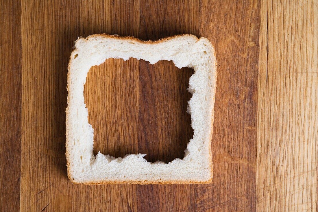 The middle removed from a slice of bread