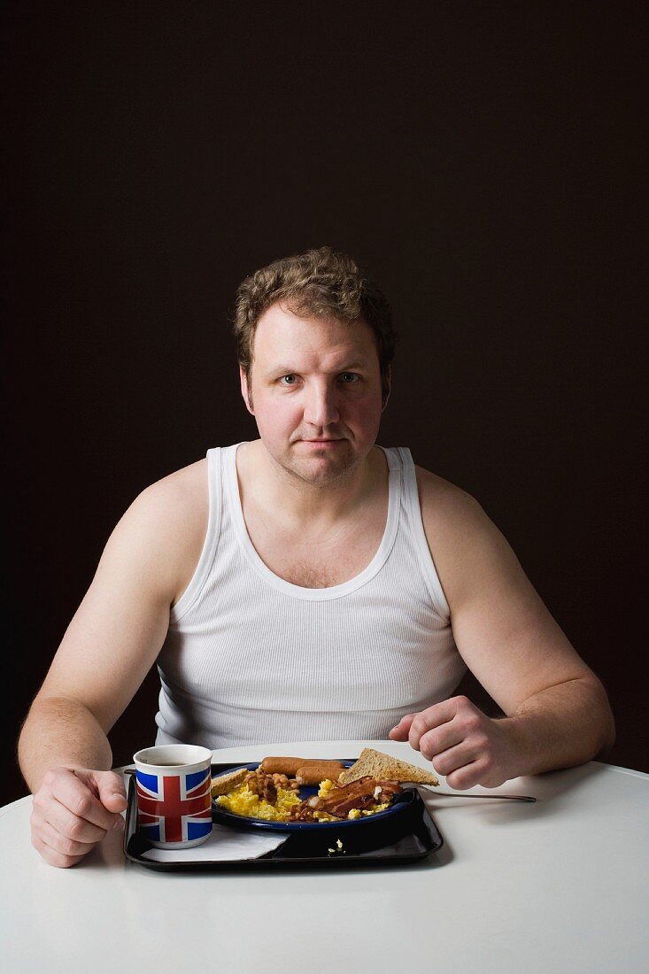 A stereotypical Englishman eating breakfast