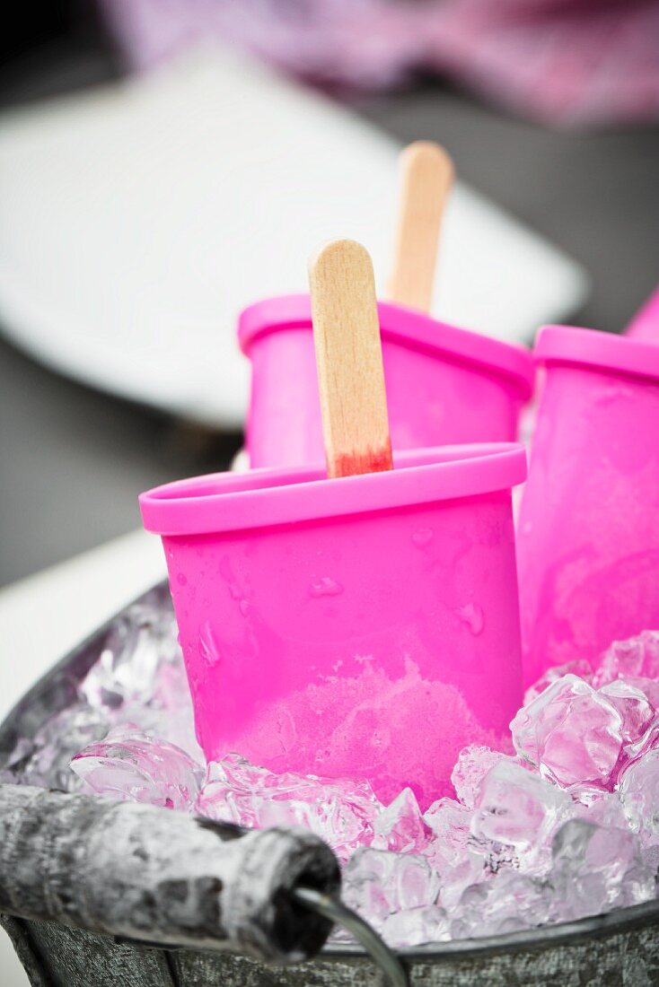 A zinc tub filled with crushed ice and ice lolly makers