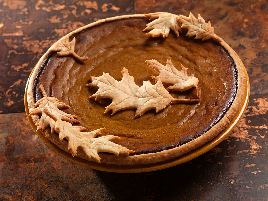 Pumpkin pie decorated with shortcrust pastry leaves