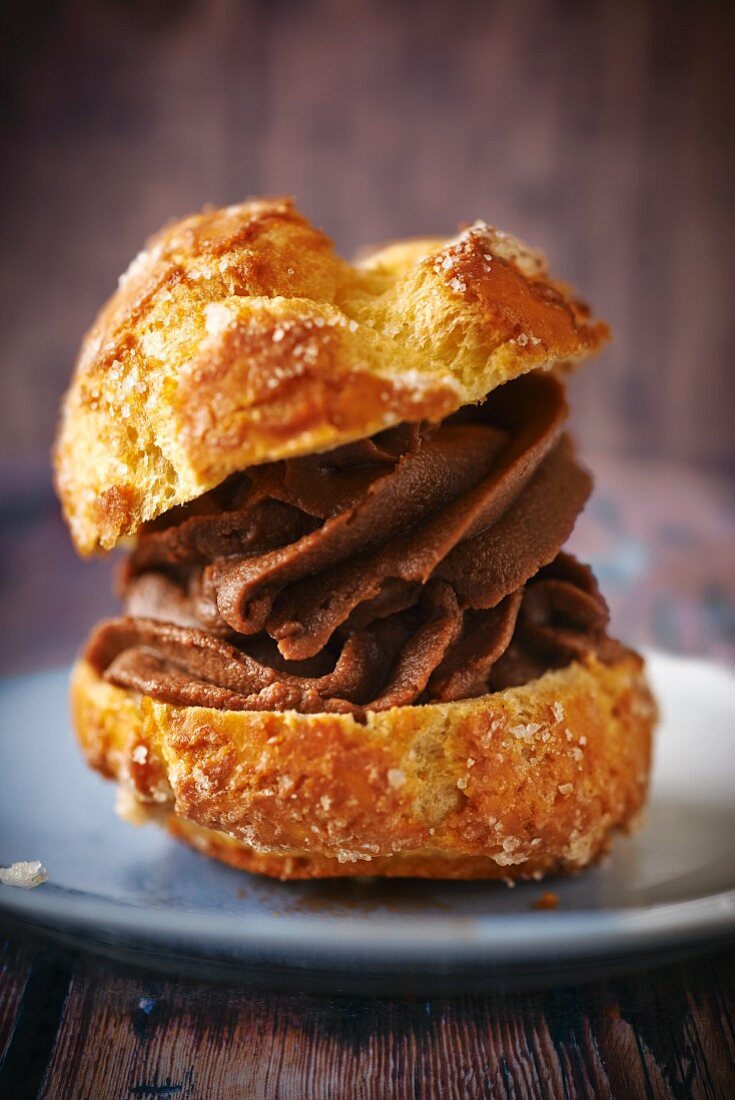 A profiterole filled with chocolate cream