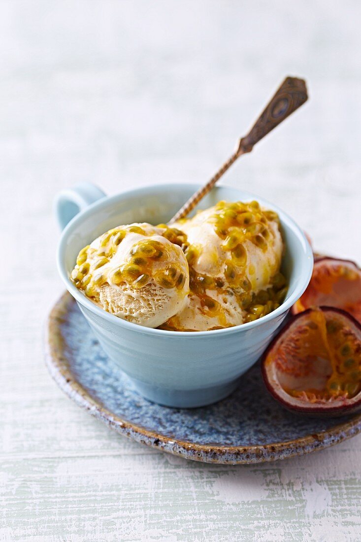 Vanilla ice cream with passion fruit sauce in a cup