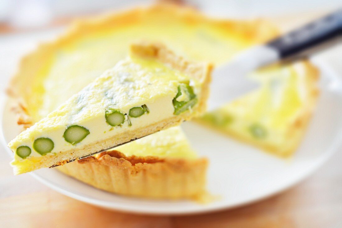 Asparagus tart, one slice on a cake server