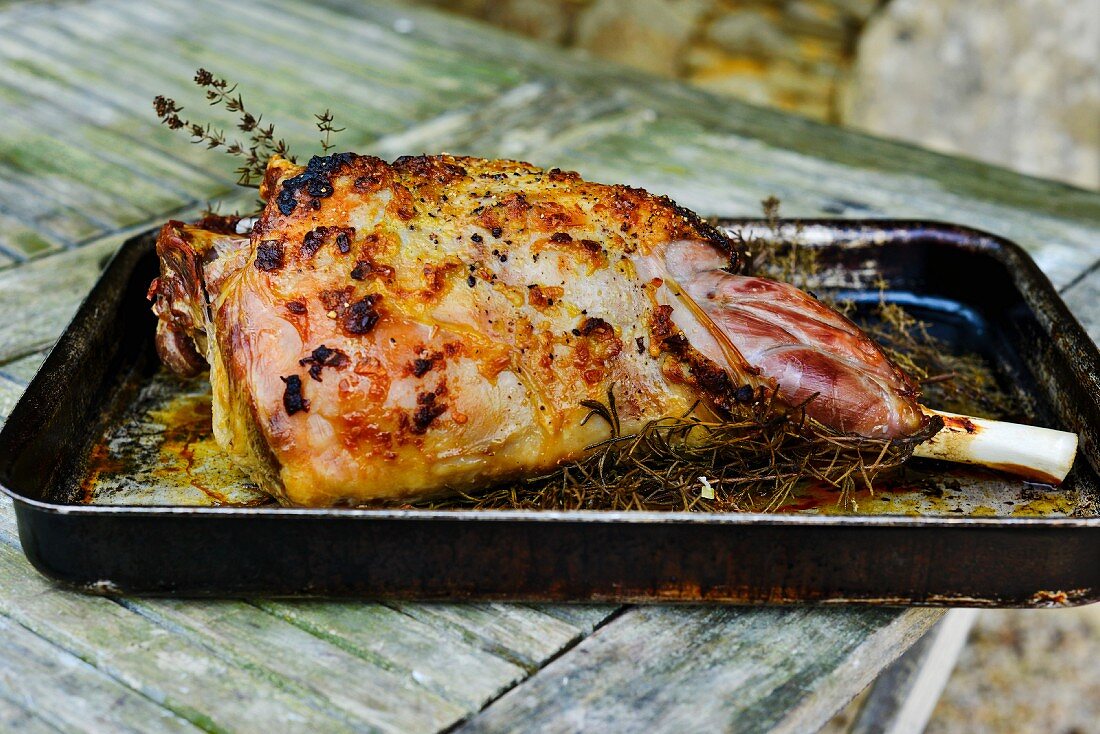 Roast leg of lamb with rosemary in a roasting tin