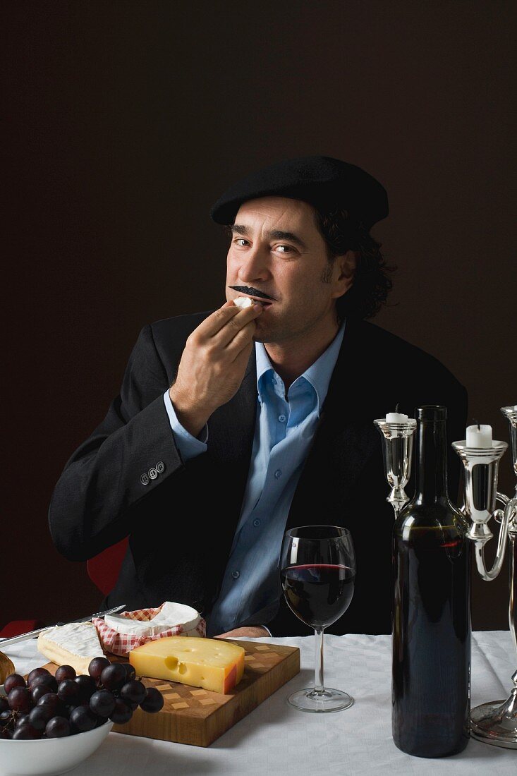 A stereotypical Frenchman tasting a piece of cheese