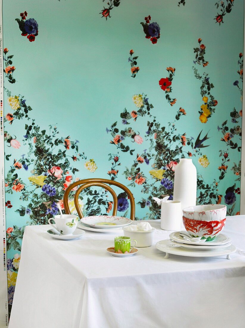 Dining area with spring atmosphere created by floral-patterned wall and floral coffee set