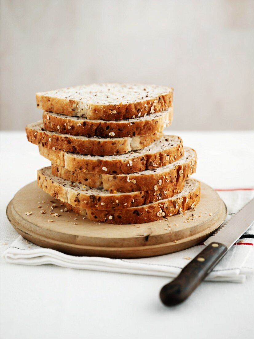 A loaf of sliced bread with oats and flax seeds