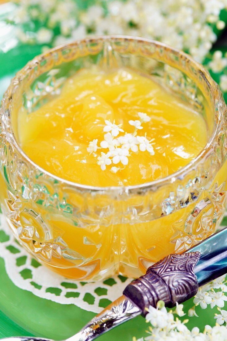 Lemon curd with elderflowers in a crystal bowl