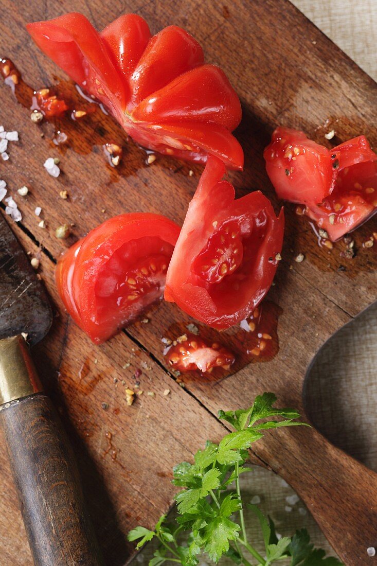 Sliced beefsteak tomatoes on a wooden board