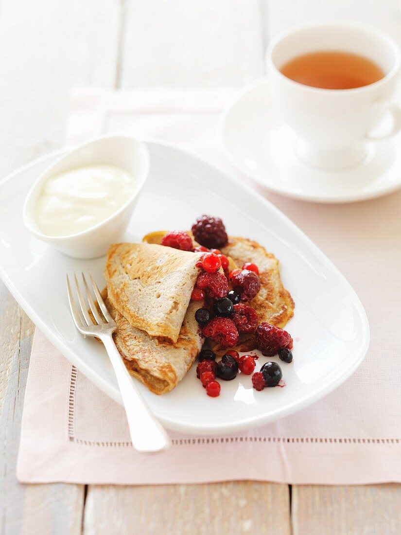 Buckwheat pancakes with berries and a cup of tea